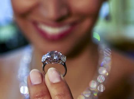 A model holds the "Historic Pink Diamond" during an auction preview at Sotheby's auction house in Geneva, Switzerland, in this May 6, 2015 file photo. REUTERS/Denis Balibouse/Files