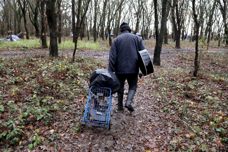 Antonio Rico removes some of his his belongings from his camp at a flooded homeless encampment on Bannon Island.