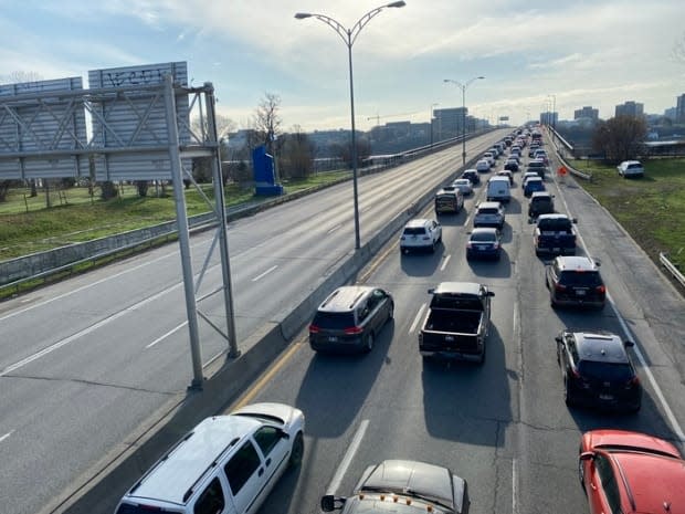 A line of drivers wait to enter Ontario on the Macdonald-Cartier Bridge, linking Ottawa and Gatineau, Que., on April 19, 2021, the first day of border checkpoints to enforce provincial rules.