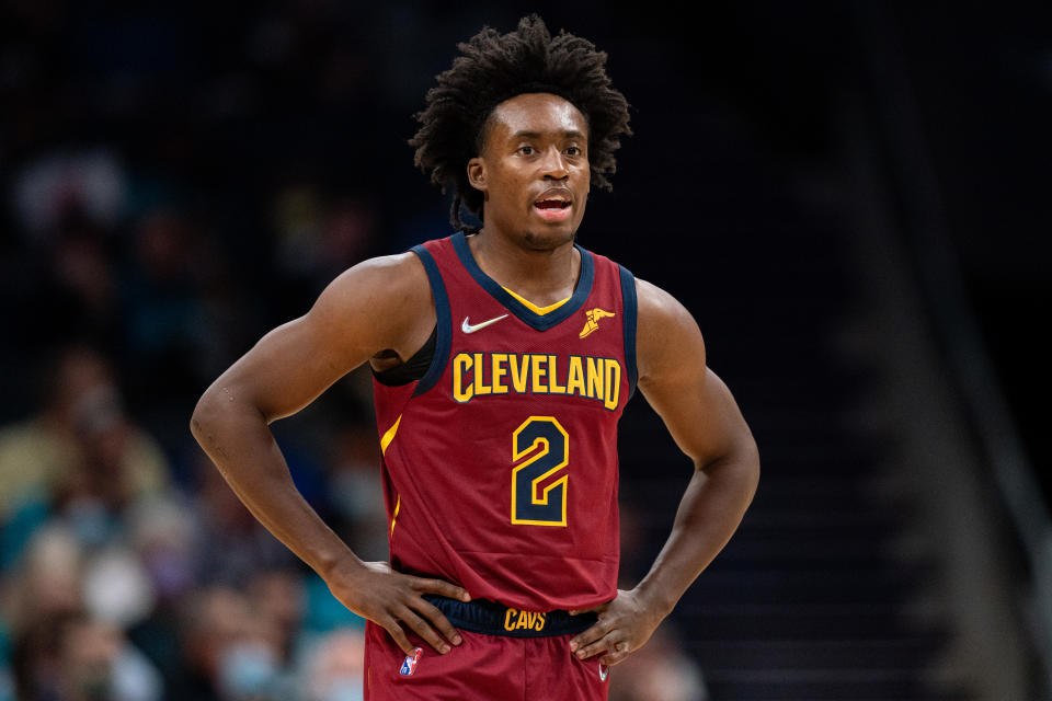 Collin Sexton, with his hands on his hips, looks on during a game.