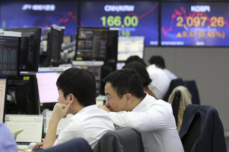 Currency traders watch monitors at the foreign exchange dealing room of the KEB Hana Bank headquarters in Seoul, South Korea, Monday, Oct. 28, 2019. (AP Photo/Ahn Young-joon)