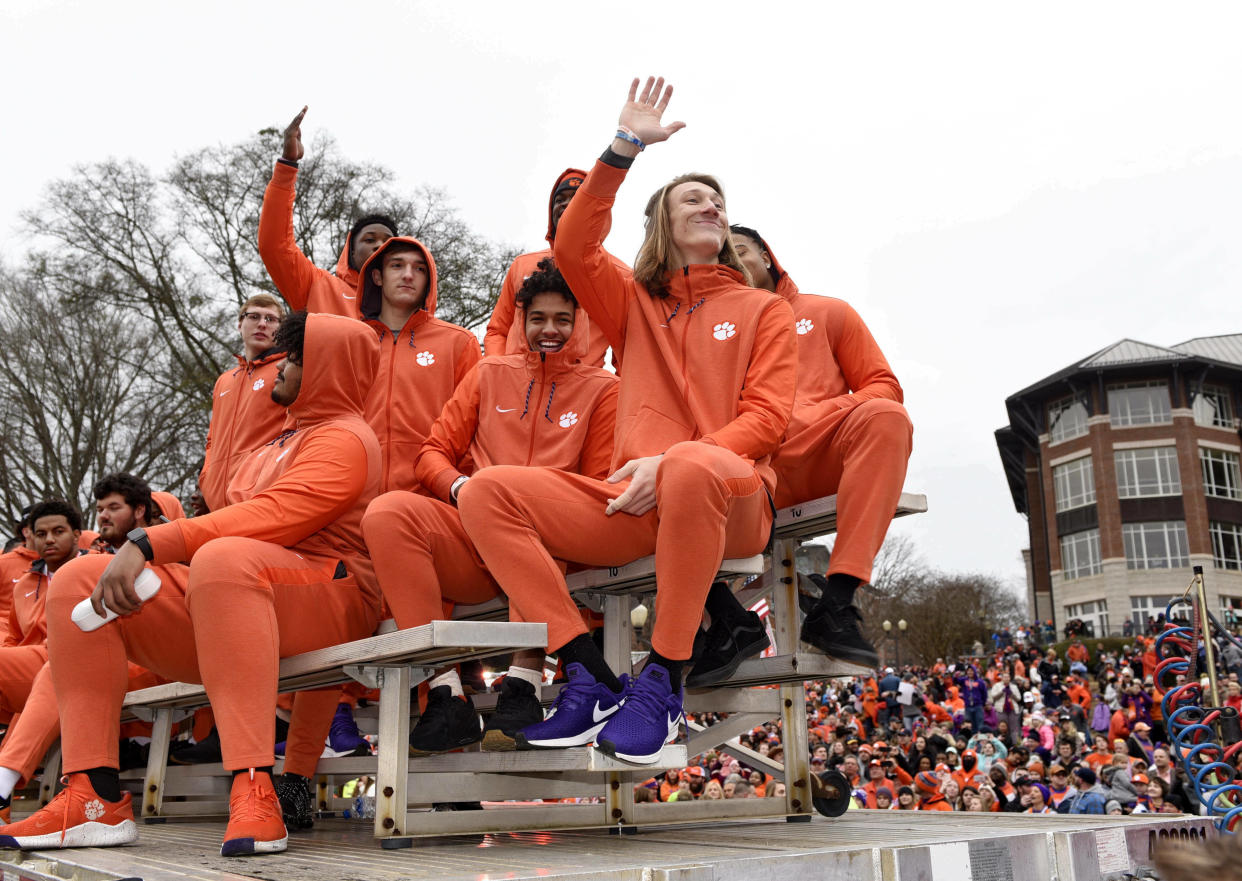 Clemson quarterback Trevor Lawrence, right, along with fellow freshmen ride in the parade honoring Clemson’s national championship win over Alabama. (AP Photo/Richard Shiro)