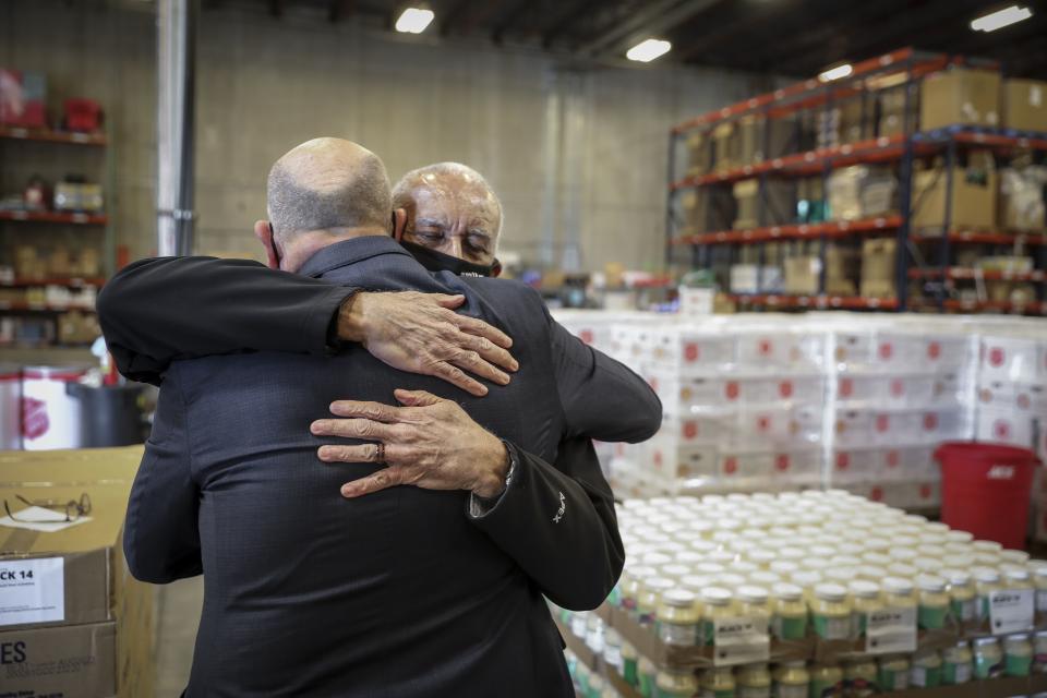 Black 14 member John Griffin, of Denver, hugs Elder Rick Balli, of Centennial, Colo., after sharing his thoughts on a food donation partnership with The Church of Jesus Christ of Latter-Day Saints at the Salvation Army’s Emergency Service Center in Aurora, Colo., on Tuesday Nov. 17, 2020. Food donated by the Church of Jesus Christ was unloaded and and will be redistributed to a number of charities in Colorado. | Marc Piscotty, for the Deseret News