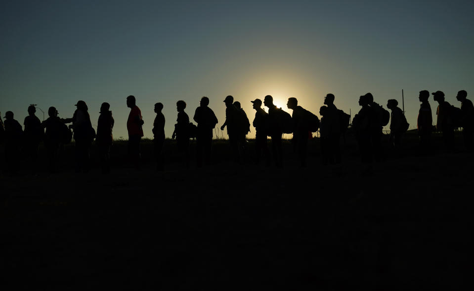 FILE - Migrants who crossed the Rio Grande and entered the U.S. from Mexico are lined up for processing by U.S. Customs and Border Protection on Saturday, Sept. 23, 2023, in Eagle Pass, Texas. President Joe Biden’s nearly $106 billion aid package for Ukraine, Israel and other needs sits idle in Congress, neither approved nor rejected, but subjected to new political demands. Republicans are insisting on U.S.-Mexico border policy provisions in exchange for any new funds for Ukraine to fight Russia. (AP Photo/Eric Gay, File)