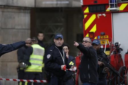 French police and emergency services are seen in front of the street entrance of the Carrousel du Louvre in Paris, France, February 3, 2017 after a French soldier shot and wounded a man armed with a machete and carrying two bags on his back as he tried to enter the Paris Louvre museum. REUTERS/Christian Hartmann