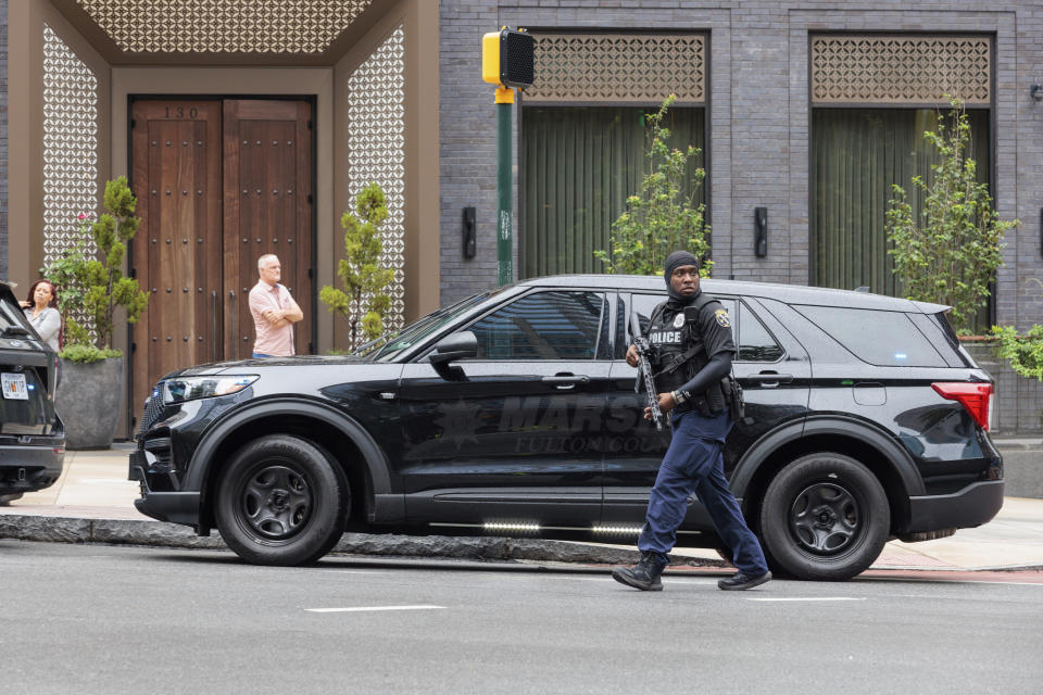 Police block 14th Street between Peachtree and Juniper in Atlanta on Monday, Aug. 22, 2022 following reports of an active shooting in the area. (Arvin Temkar/Atlanta Journal-Constitution via AP)
