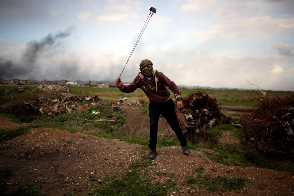 <p>A Palestinian protester holds a sling as he poses for a photograph at the scene of clashes with Israeli troops near the border with Israel, east of Gaza City, Jan. 19, 2018. “What I can do to stop Trump’s decision on Jerusalem is to use this sling to hurl stones at Israeli soldiers with heavy weapons,” he said. “My dream is to see all Arabs and Muslims united in one battle to restore our holy land.” (Photo: Mohammed Salem/Reuters) </p>