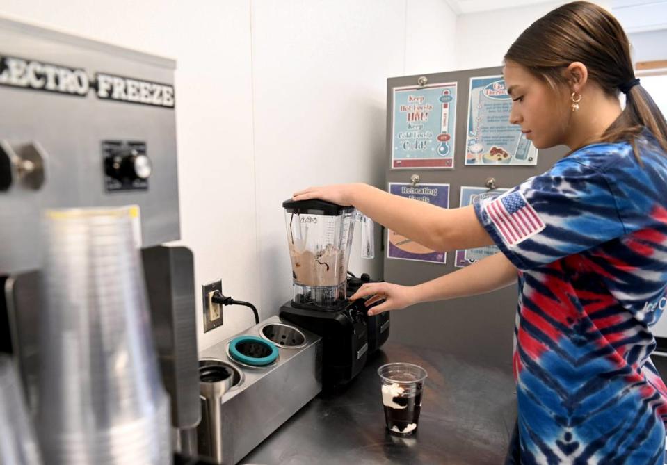 Callie Riddle makes a Boston Shake at Riddle’s Ice Cream Shop on Thursday, March 7, 2024.