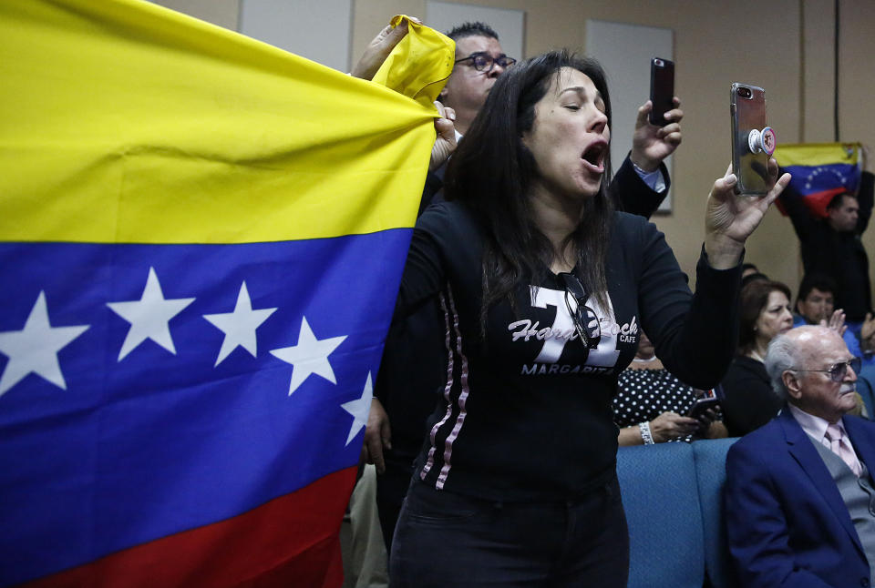 A supporter cheers and celebrates during Vice President Mike Pence's speech at Iglesia Doral Jesus Worship Center on the political crisis in Venezuela on Friday, Feb. 1, 2019, in Doral, Fla. (AP Photo/Brynn Anderson)