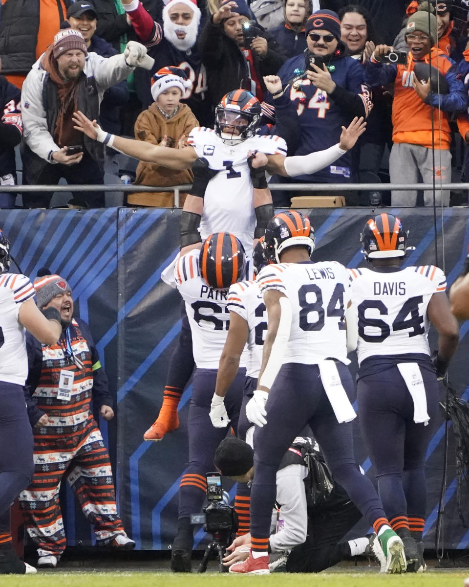 Chicago Bears quarterback Justin Fields celebrates his touchdown with teammates during the first half of an NFL football game against the Arizona Cardinals, Sunday, Dec. 24, 2023, in Chicago. (AP Photo/David Banks)