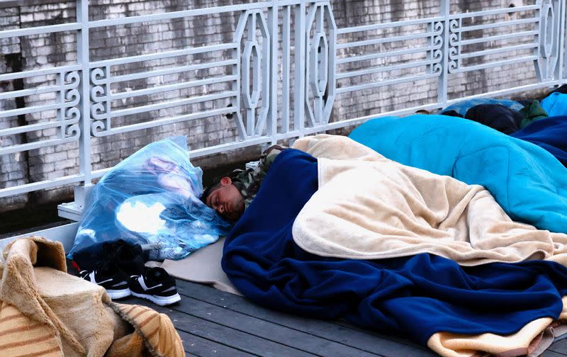 Asylum seekers sleep on a street in central Brussels