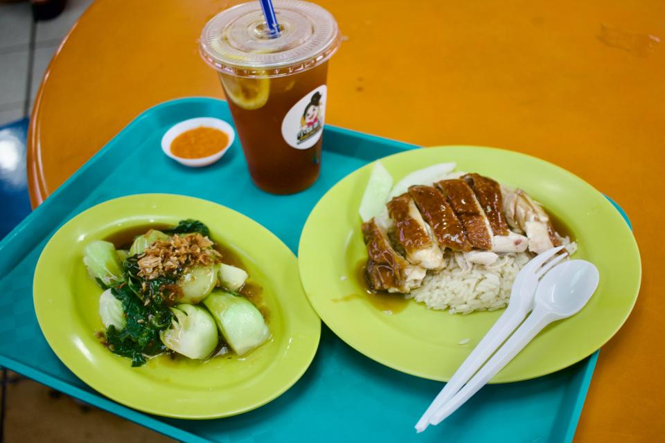 a plate of chicken rice and veggies