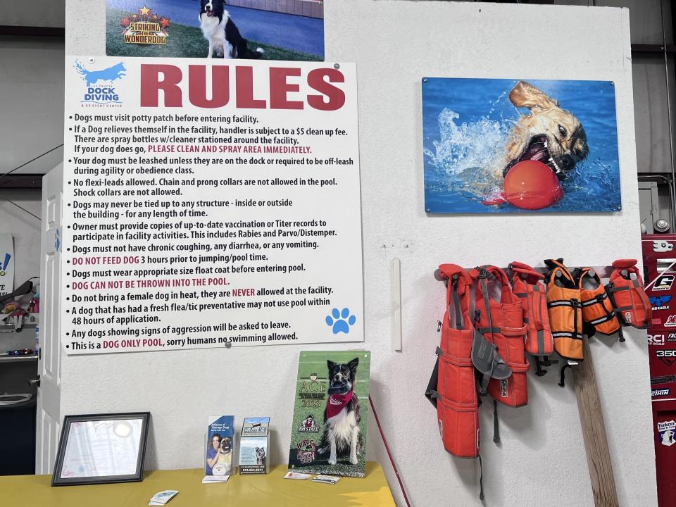 The rules and life-sized jackets for dogs at the facility.