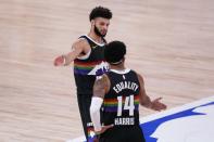 Denver Nuggets' Jamal Murray, rear, and Gary Harris (14) celebrate their 114-106 win against the Los Angeles Lakers in Game 3 of the NBA basketball Western Conference final Tuesday, Sept. 22, 2020, in Lake Buena Vista, Fla. (AP Photo/Mark J. Terrill)