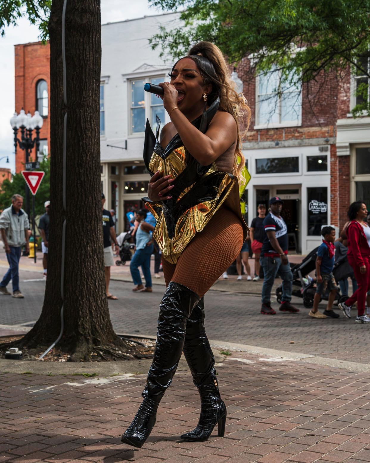 Durham-based drag queen Naomi Dix performs outside of The Sip Room on Hay Street in Fayetteville during the Dogwood Festival, April 27, 2024.