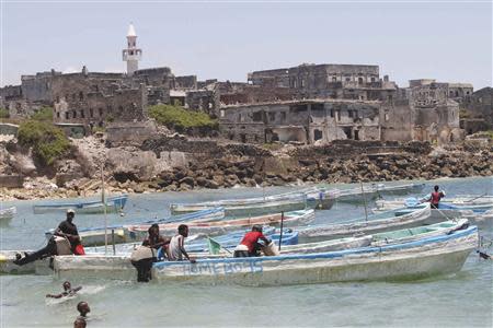 Fishermen sit in their boats in the Hamaerweyne area of Mogadishu October 12, 2013. REUTERS/Feisal Omar