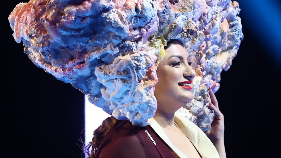 Miss Nepal's look was topped by a large-scale, homespun headpiece seemingly crafted from foam and spray paint — a representation of an exploding bomb's dust cloud, and additional missiles above it. - Hector Vivas/Getty Images