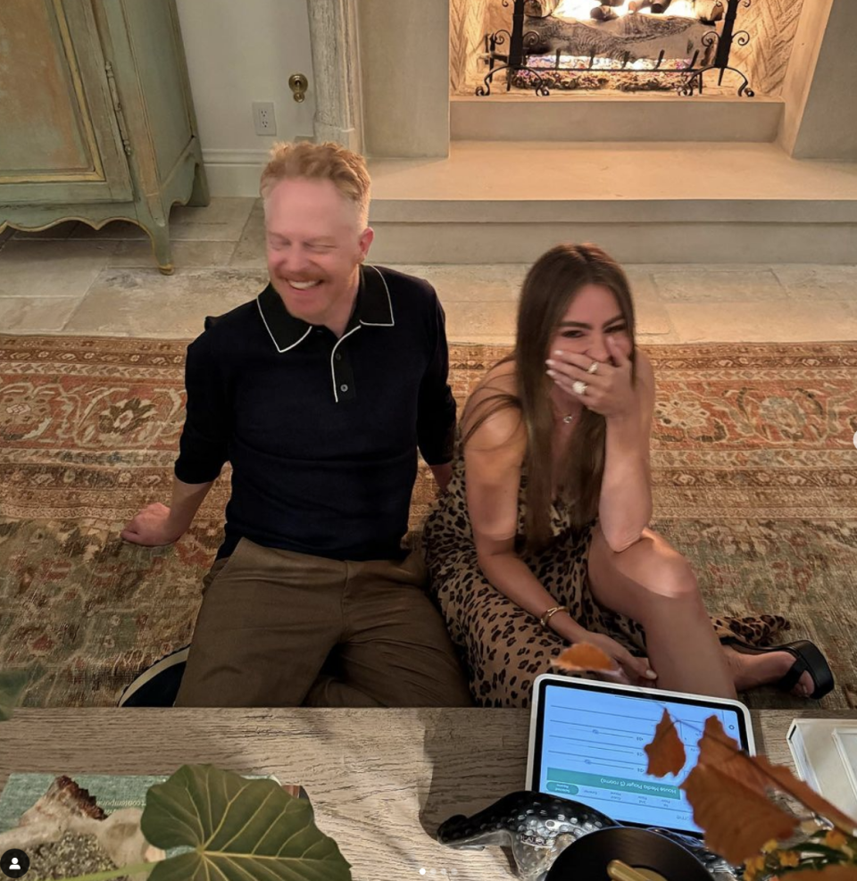 Sofia and Jesse laughing on the floor at the party