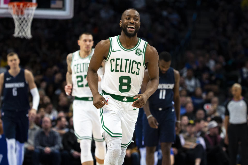 Boston Celtics guard Kemba Walker (8) smiles as he runs down the court after making a 3-pointer during the second half of the team's NBA basketball game against the Dallas Mavericks on Wednesday, Dec. 18, 2019, in Dallas. (AP Photo/Sam Hodde)