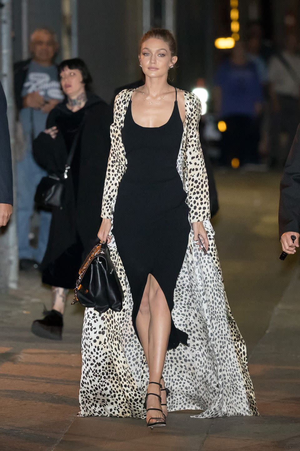 <p>In a black Nanushka slip dress, Stuart Weitzman sandals, a black handbag and cheetah print silk robe while out in New York City.</p>