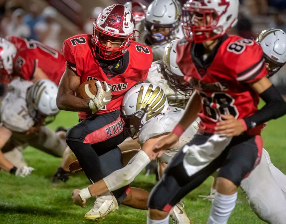 Pekin running back Kanye Tyler tears through the Dunlap defense in the second half Friday, Sept. 10, 2021 in Pekin. The Dragons defeated the Eagles 27-7.
