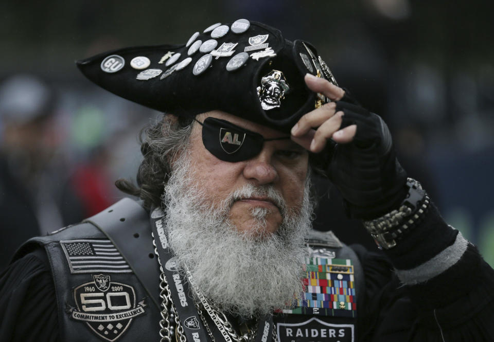 An Oakland Raiders supporter poses for a photo on Wembley Way before an NFL football game against Seattle Seahawks at Wembley stadium in London, Sunday, Oct. 14, 2018. (AP Photo/Tim Ireland)