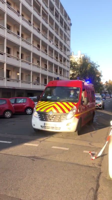 An ambulance is seen at the scene where an Orthodox priest was shot and injured as the assailant fled, as police source claims, in Lyon