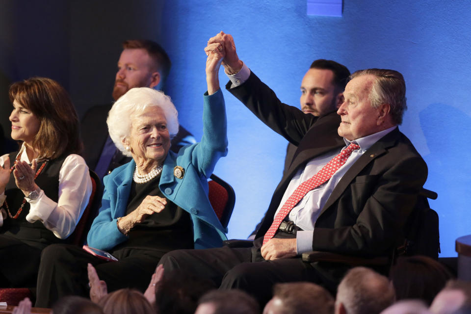 Barbara and George H.W. Bush hold up their hands at the Republican presidential primary debate sponsored by CNN and Telemundo at the University of Houston on Feb. 25, 2016.