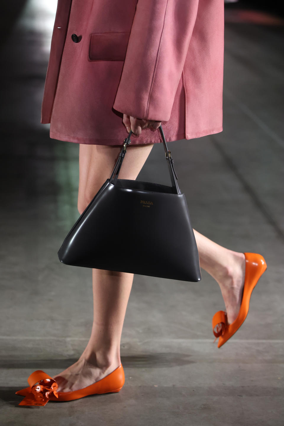 Origami-esque flats and trapeze bags at Prada women’s fall winter ’23 at Milan Fashion Week. - Credit: WireImage