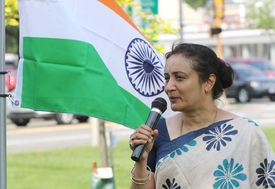 With the flag of India flying next to her, Padmini Balaji, of Littleton (USAT photo)