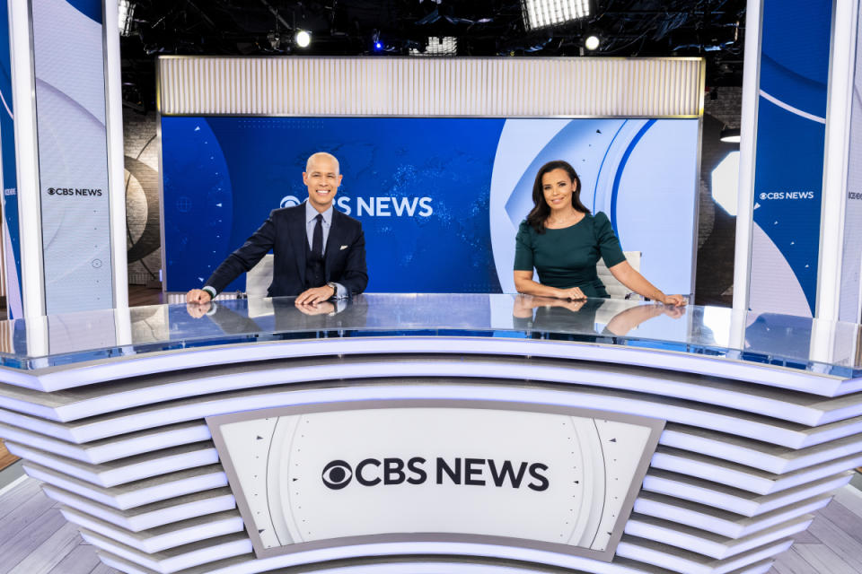 CBS News anchors Vladimir Duthiers, left, and Ann-Marie Green CBSN News Studio in New York. CBS News says it is retooling its streaming service to better incorporate programs and personalities from the television network. The service debuts a new evening newscast on Monday, Jan. 24, 2022, along with a series of prime-time programs that make use of work done on "60 Minutes," "CBS Sunday Morning" and other shows. (Mary Kouw/CBS via AP)