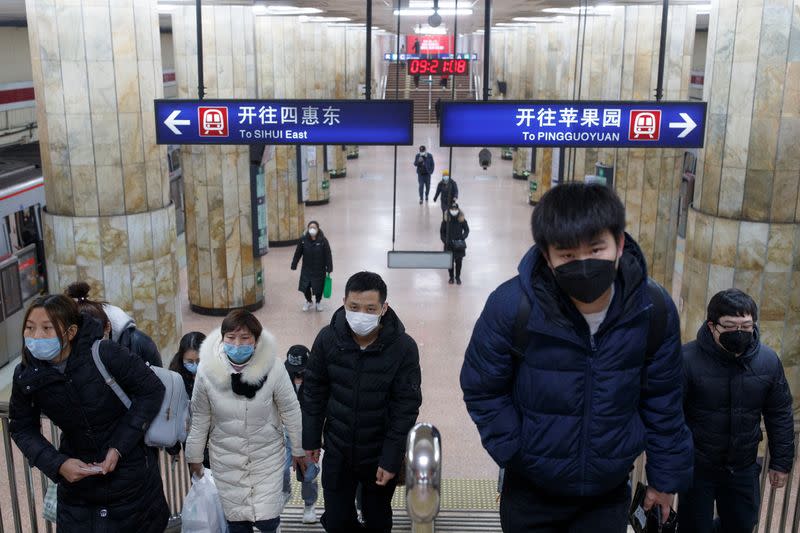 People wear face masks as they change subway lines in Beijing as the country is hit by an outbreak of the novel coronavirus