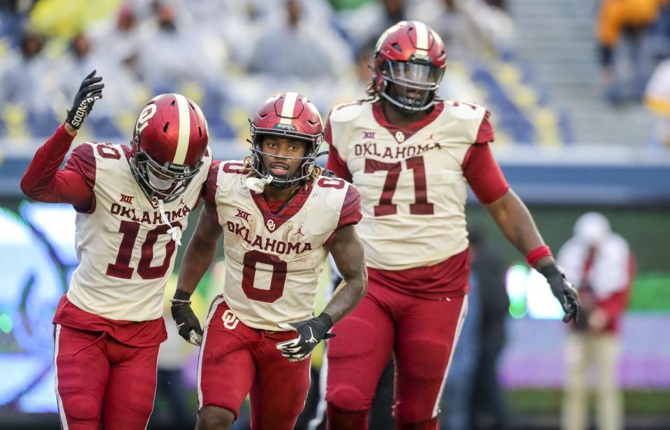 Nov 12, 2022; Morgantown, West Virginia, USA; Oklahoma Sooners running back Eric Gray (0) celebrates with teammates after scoring a touchdown during the third quarter against the West Virginia Mountaineers at Mountaineer Field at Milan Puskar Stadium. Mandatory Credit: Ben Queen-USA TODAY Sports