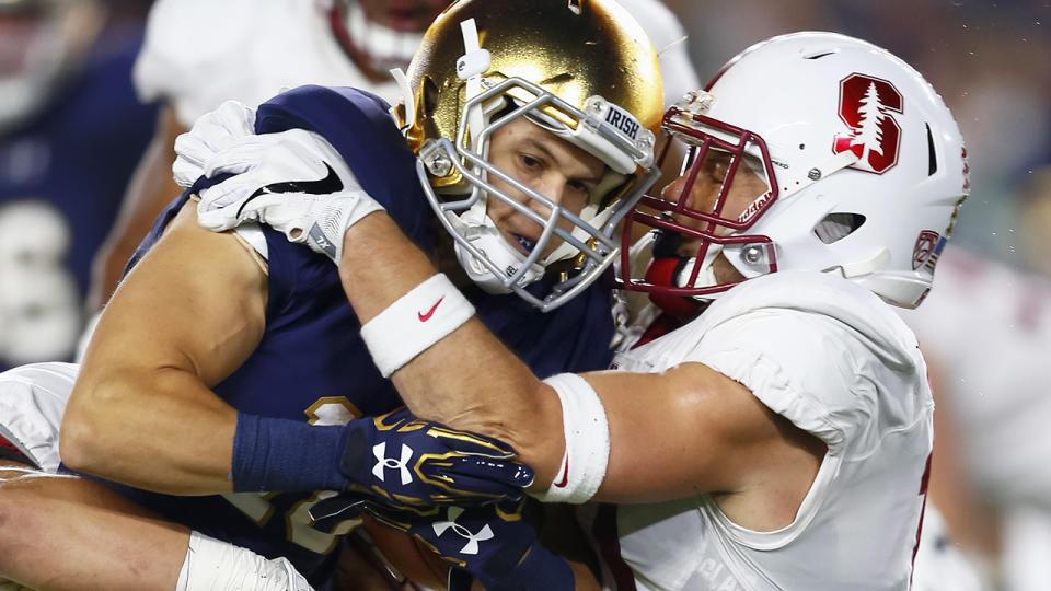 Chris Finke of Notre Dame, pictured here being tackled by Zach Hoffpauir of the Stanford Cardinal in 2016. 