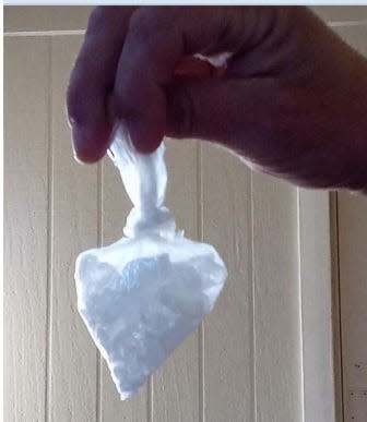 A convicted Downriver drug dealer photographs a packet of methemphetamine using his cellphone. He was convicted of concocting lethal meth shots that cost two people their lives. This photo was seized by the FBI during its investigation.
