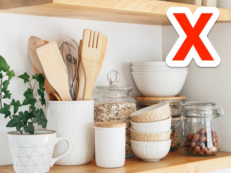 red x over open shelving in a white and light wood kitchen