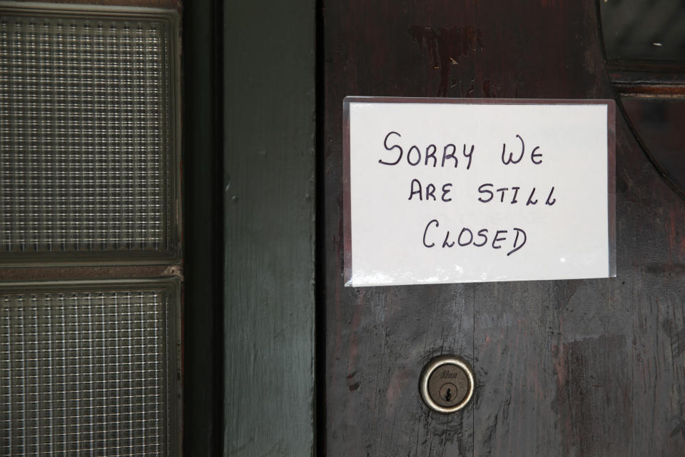 CHESTERTON, INDIANA - MAY 13: A sign on the door of Flannery's Tavern lets customers know the business is still closed on May 13, 2020 in Chesterton, Indiana. Recently, Indiana began allowing some business in the state to reopen with some restrictions. The governor had issued a stay-at-home in March, restricting all but essential travel and a shuttering all but essential businesses in an attempt to stop the spread of the COVID-19 pandemic. Despite this order being lifted many businesses remain closed and many, that have re-opened, report lackluster business as fears of COVID-19 continue.  (Photo by Scott Olson/Getty Images)