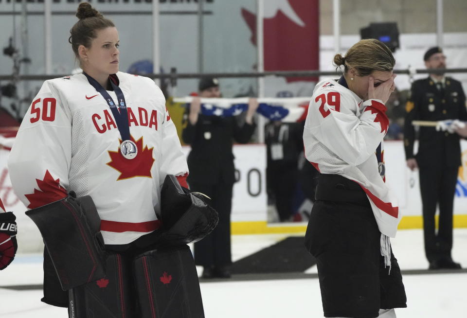 Canada forward Marie-Philip Poulin (29) and goaltender Kristen Campbell (50) react after their defeat during a gold medal game against the United States at women's world hockey championships in Brampton, Ontario, Sunday, April 16, 2023. (Nathan Denette/The Canadian Press via AP)