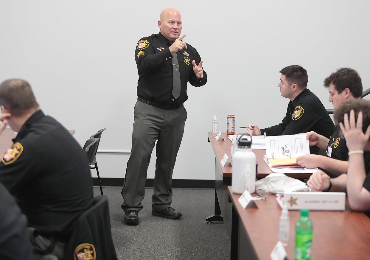 Sgt. Jeff Begue, of the Stark County Sheriff's Office, instructs a class of cadets Wednesday morning at the Stark County Law Enforcement Training Center in Massillon. Begue, also a training instructor, was reviewing de-escalation tips with cadets who will need quality communication skills to eventually engage with jail inmates.