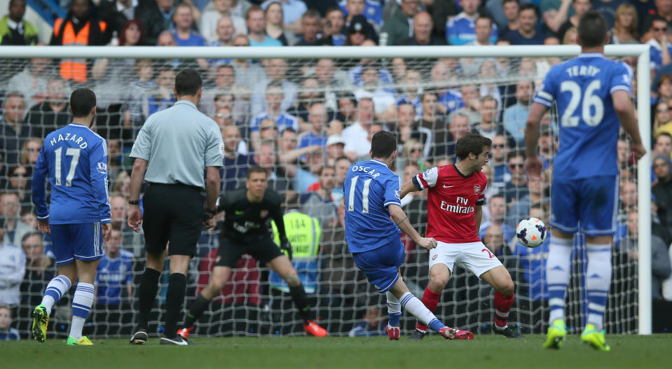 Chelsea's Oscar, right right, , shoots and scores his side's 5th goal during their English Premier League soccer match between Chelsea and Arsenal at Stamford Bridge stadium in London, Saturday, March, 22, 2014. (AP Photo/Alastair Grant)