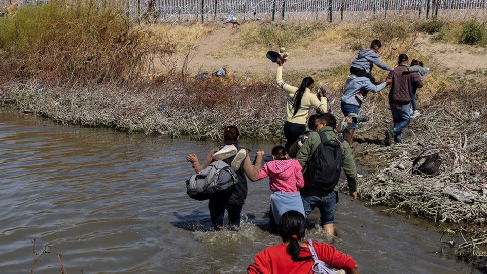 Migrants cross the border from Mexico into Texas. - David Peinado/NURPHO/AP/File