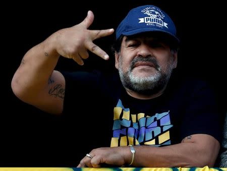 Former Argentine soccer player Diego Maradona gestures from a balcony as he attends the Argentine First Division soccer match between Boca Juniors and Quilmes at La Bombonera stadium in Buenos Aires July 18, 2015. REUTERS/Marcos Brindicci