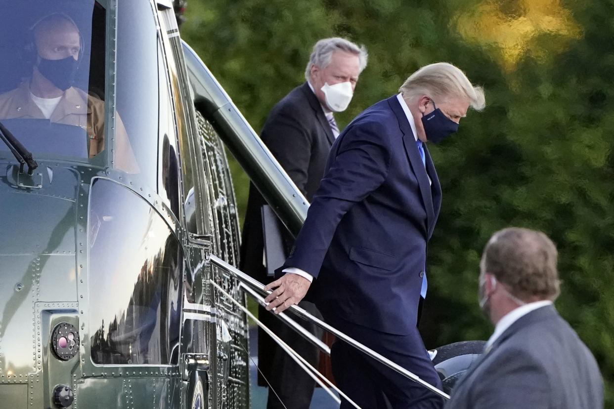 President Donald Trump arrives at Walter Reed National Military Medical Center, in Bethesda, Md., Friday, Oct. 2, 2020, on Marine One helicopter after he tested positive for COVID-19. White House chief of staff Mark Meadows is at second from left. 