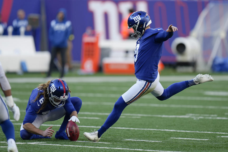 New York Giants' Graham Gano, right, kicks a field goal as Jamie Gillan (6) holds for him during the first half of an NFL football game against the Indianapolis Colts, Sunday, Jan. 1, 2023, in East Rutherford, N.J. (AP Photo/Seth Wenig)