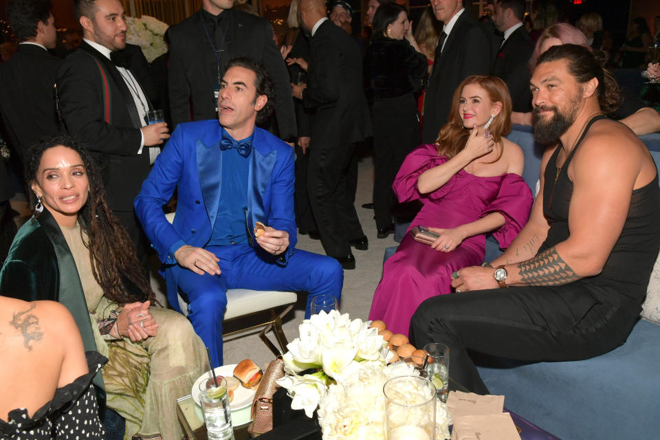 Jason Momoa (right, pictured with Lisa Bonet, Sacha Baron Cohen and Isla Fisher) later reappeared in the tank top at a Golden Globes after-party. (Photo: Lester Cohen via Getty Images)