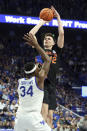 Florida's Colin Castleton, top, shoots while defended by Kentucky's Oscar Tshiebwe (34) during the second half of an NCAA college basketball game in Lexington, Ky., Saturday, Feb. 4, 2023. (AP Photo/James Crisp)