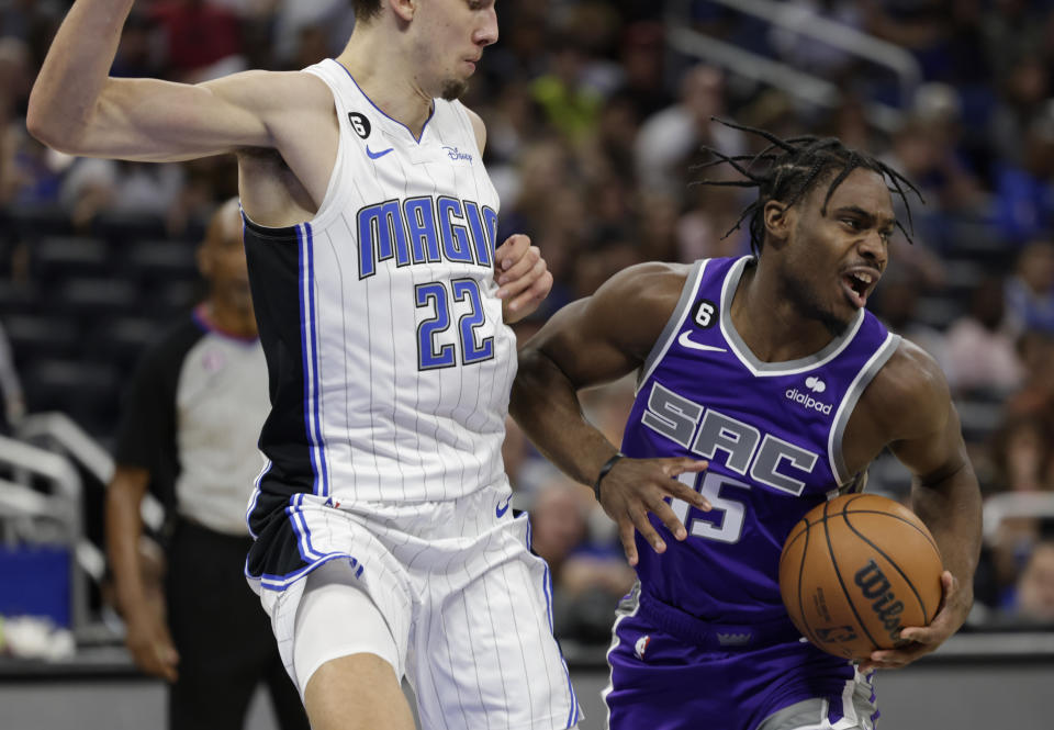 Sacramento Kings guard Davion Mitchell (15) drives against Orlando Magic forward Franz Wagner (22) during the first half of an NBA basketball game, Saturday, Nov. 5, 2022, in Orlando, Fla. (AP Photo/Kevin Kolczynski)