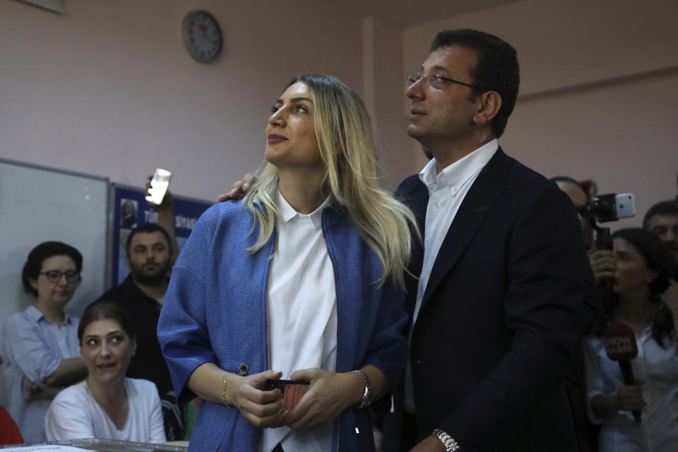 Ekrem Imamoglu, right, candidate of the secular opposition Republican People's Party, or CHP, and his wife Dilek pose for the photographers at a polling station in Istanbul, Sunday, June 23, 2019. Voters in Istanbul returned to the polls Sunday for a re-run mayoral election ordered up by authorities after President Recep Tayyip Erdogan and his political allies lost control of Turkey's largest city for the first time in 25 years. (AP Photo/Burhan Ozbilici)