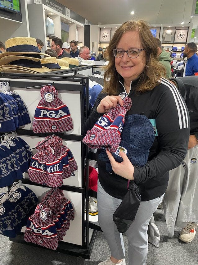 Kim Roth of Cleveland, Ohio, was one of many golf fans to buy knit beanies at the PGA Championship Merchandise Center Wednesday.