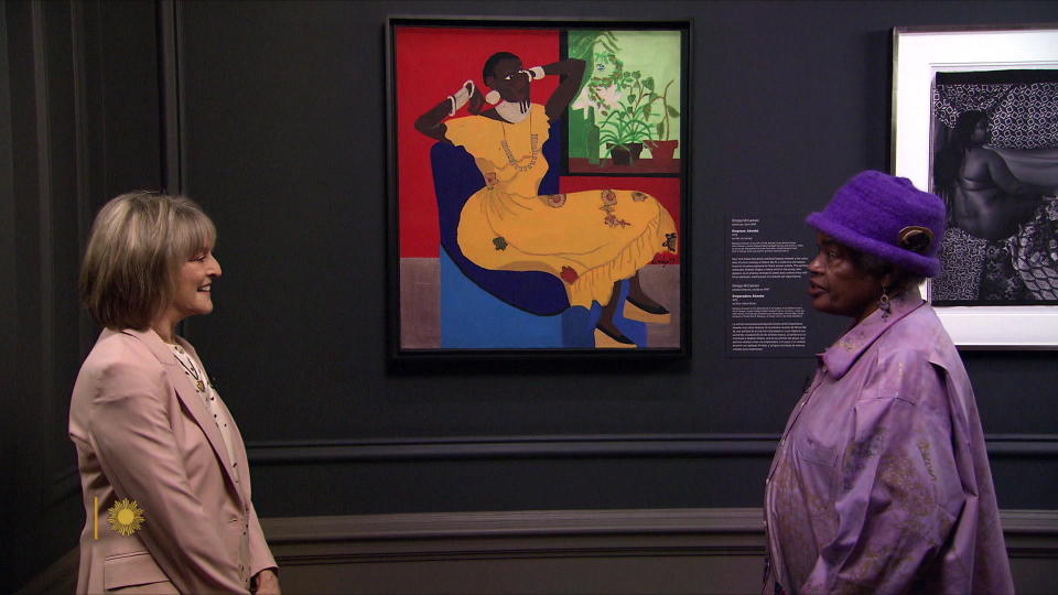 Artist Dindga McCannon shows correspondent Rita Braver her painting, 